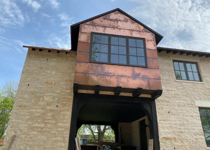 Copper metal panel facade on a stone building for Roof Repair in Ivins