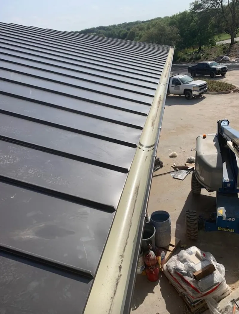 Standing seam panel and gutter detail on a metal roofing jobsite in Ivins